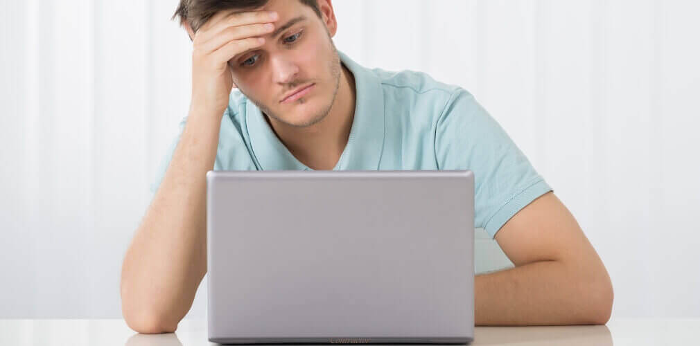 Worried contractor looking at a laptop, concerned about an IR35 investigation and tax status.