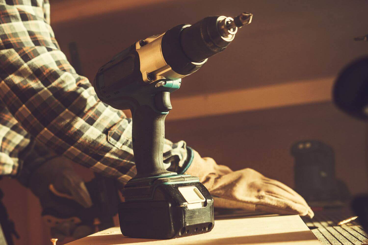 Image of a handheld drill on a work bench, representing guide on how to insure work tools for tradespeople